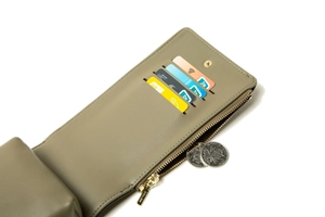 Detail of crossbody phone bag showing four card slots and gold zipper coin pocket