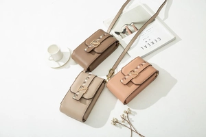 Three elegant PU leather crossbody phone bags with gold leaf clasps and floral straps
