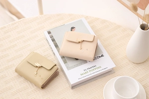 Detailed macro view of short PU leather wallets with heart pattern and metal pendants