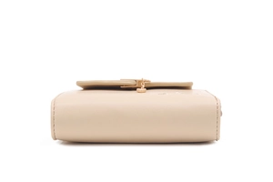 Detailed bottom view of a beige leather wallet with heart pendant and precise stitching