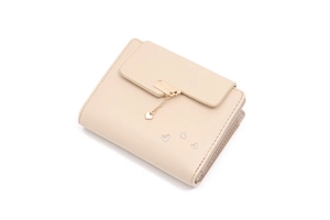 Close-up of beige wallet featuring silver glitter hearts and a gold heart pendant