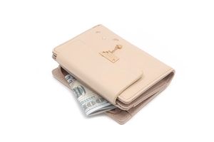 Detail of beige bi-fold wallet showing dollar bill compartment and heart-shaped pendant