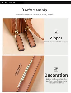 Detail of brown faux leather wallet featuring double zippers and Forever Better embossing