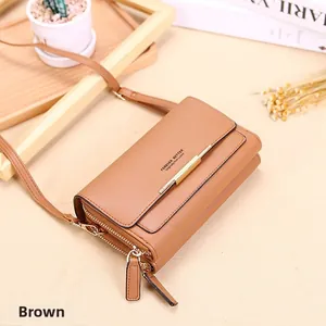 Close-up of brown litchi texture crossbody wallet with double zippers and gold bar detail