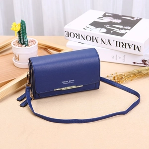 Detail of dark blue leather texture with golden bar hardware and adjustable shoulder strap