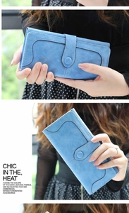 Detail view of sky blue frosted wallet with snap closure and decorative stitching accents