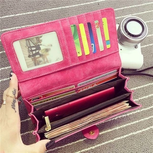 Pink matte long wallet with multiple card slots and zipper pocket in a handheld view