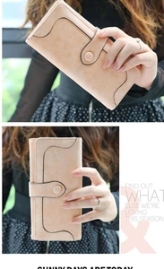 Close-up of minimalist women's long wallet featuring matte texture and snap closure