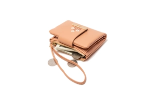 Detail of compact beige PU leather wallet with floral print and metal zipper closure