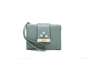 Close-up of pebble grain PU leather wallet featuring daisy embroidery and metal clasp