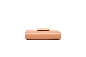 Detail view of the flat bottom on a lychee grain leather wallet with golden clasp