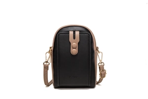 Close-up of black and beige phone bag featuring golden hardware and dual zippers