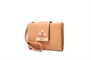 Detail view of apricot PU leather wallet with daisy print and gold metal buckle