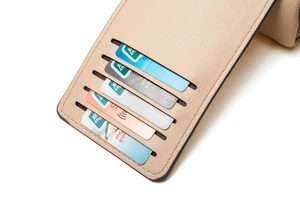 Detailed interior of beige lychee leather phone bag showing five organized card slots