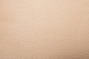 Macro shot of high-quality lychee grain leather in elegant beige for women crossbody bag