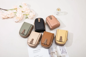 Overhead view of colorful lychee texture crossbody bags with dual zippers and gold studs