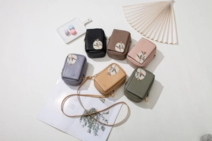 Detailed view of six floral patterned mini crossbody phone bags in various pastel colors