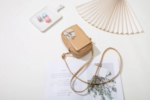 Detailed overhead view of a khaki PU leather phone bag with elegant floral prints
