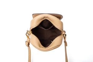 Overhead view of compact crossbody phone bag with gold zipper and interior compartment