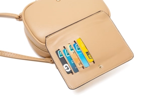 Detail view of beige PU leather crossbody bag featuring five functional card slots