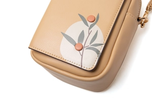 Detailed close-up of khaki PU crossbody bag with floral print and pink accents
