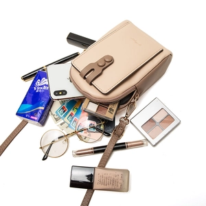 Minimalist beige crossbody phone bag with zipper and flap closure shown with daily essentials