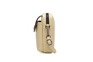 Vue détaillée du sac bandoulière beige avec texture grainée et boucles en métal