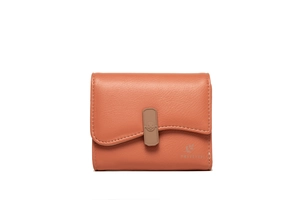 Close-up of brick red pebble grain leather wallet with unique wave flap and floral icon