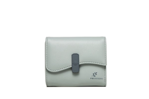Detail of light green pebble leather wallet with scalloped flap and embossed buckle