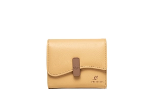 Detail view of yellow lychee texture wallet with wavy flap and brown buckle decorative