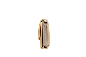 Side view of beige leather wallet showing multi-layered structure and smooth metal zipper