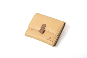 Close-up of ginger yellow short leather wallet featuring litchi grain and side card slots