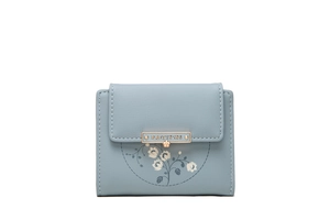 Detailed view of grey blue PU leather wallet with white floral print and gold metal bar