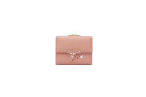 Detail of light pink tri-fold wallet featuring floral print and gold metal logo plaque