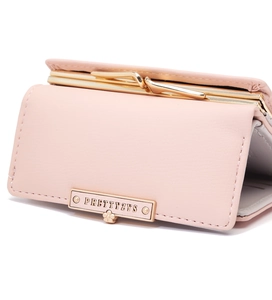 Close-up of pink PU leather wallet showing gold kiss-lock frame and metal logo detail