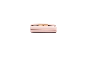 Detail view of pink PU leather wallet with elegant gold metal buckle and smooth texture