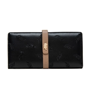 Detailed macro of a black PU leather long wallet featuring leaf embossing and gold metal leaf