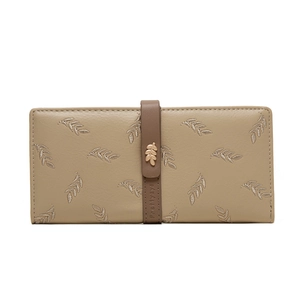 Detail of leaf embroidery and gold metal hardware on khaki leather long wallet