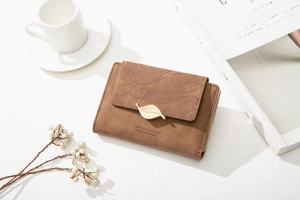 Brown women's wallet with leaf buckle, golden accents and elegant floral pattern detail
