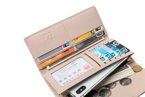 Detail of trifold faux leather wallet with multiple card slots and cash compartments