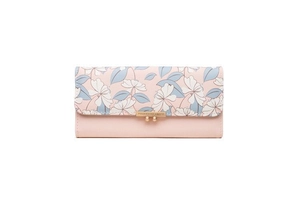Detail view of pink long wallet featuring floral print flap and gold metal snap closure