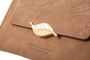 Close-up of brown frosted leather wallet featuring gold leaf buckle and leaf patterns