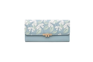 Detail of light blue floral print wallet featuring a gold snap buckle and metal logo plaque