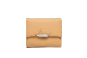 Close-up of light brown leather wallet with silver leaf buckle and elegant embroidery