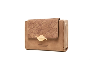 Detail of brown faux suede wallet featuring gold leaf buckle and engraved leaf pattern