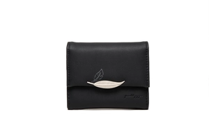 Close-up of black trifold wallet featuring silver leaf clasp and lychee leather texture