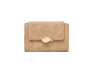 Close-up of beige frosted PU leather wallet with metallic gold leaf clasp and stitching