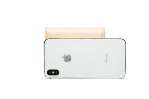 Size comparison between a beige lychee grain leather wallet and an iPhone smartphone