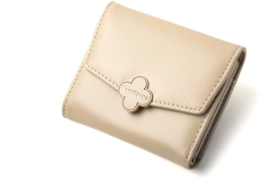Detail view of the trifold wallet with a gold clover clasp and textured beige leather