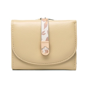 Close-up of khaki pebbled leather wallet with floral strap and gold flower clasp detail